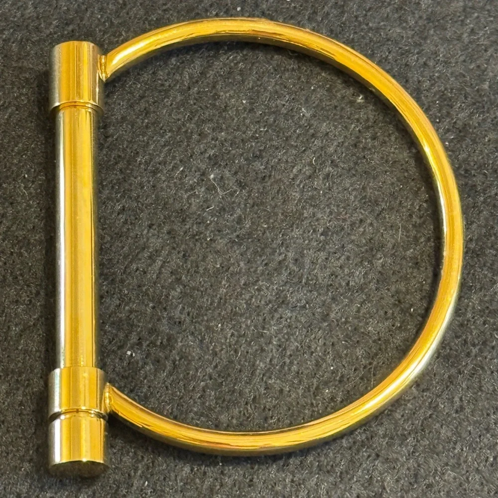 Gold tone D shaped cuff bracelet with screw closure